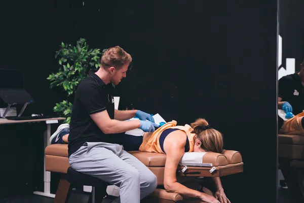 Dr. Nathan Beyerl taking a history and examining a patient before any treatment