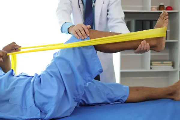 Clinician guiding a patient through a supported straight leg raise