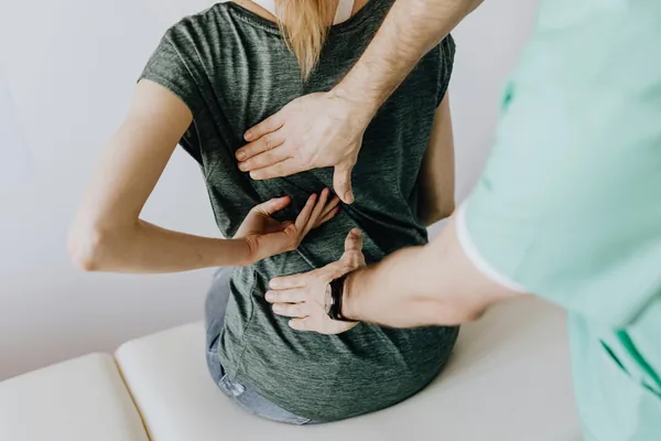Upper back and shoulder blade region, where interscapular pain is felt