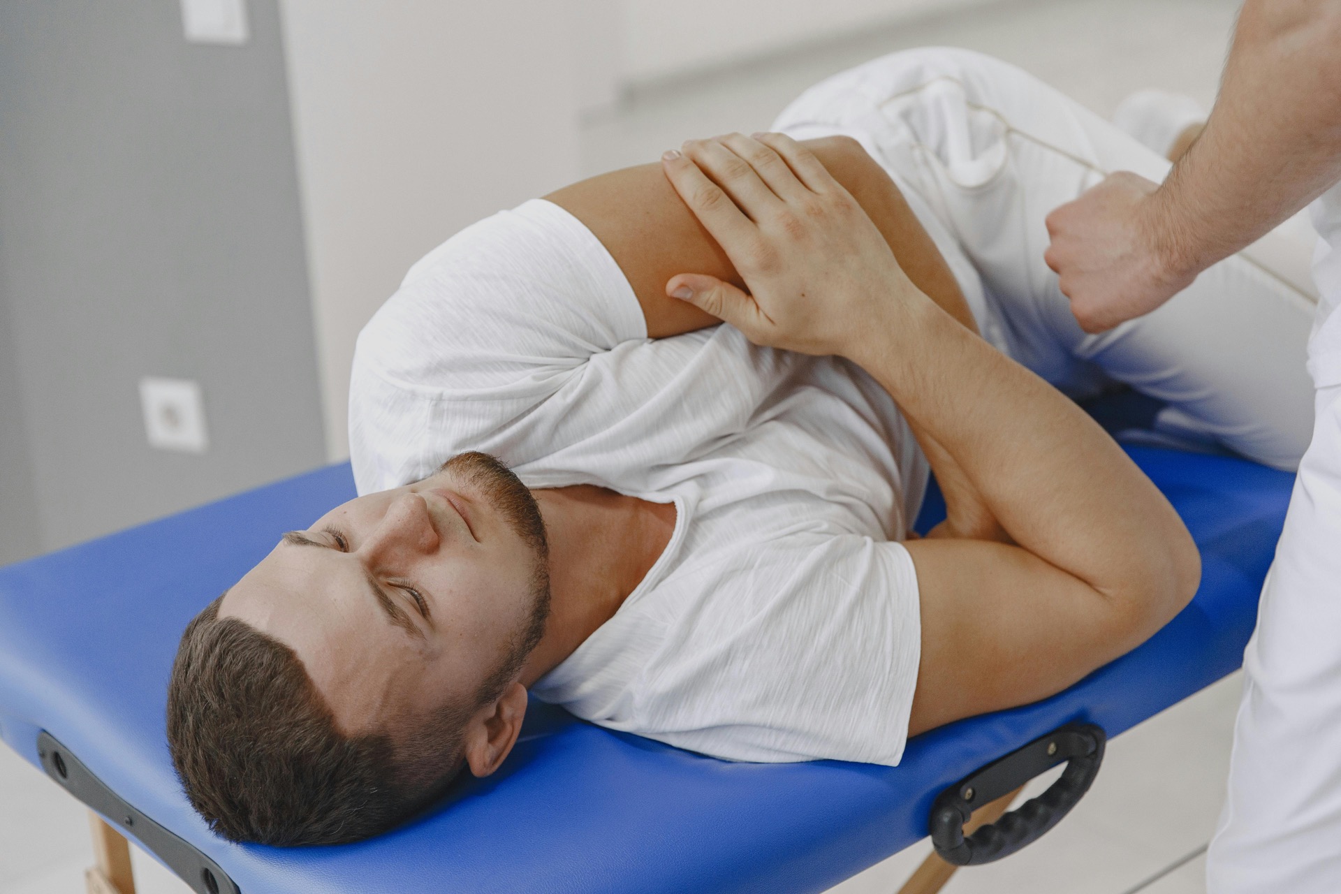 Chiropractor performing a shoulder and joint mobility assessment